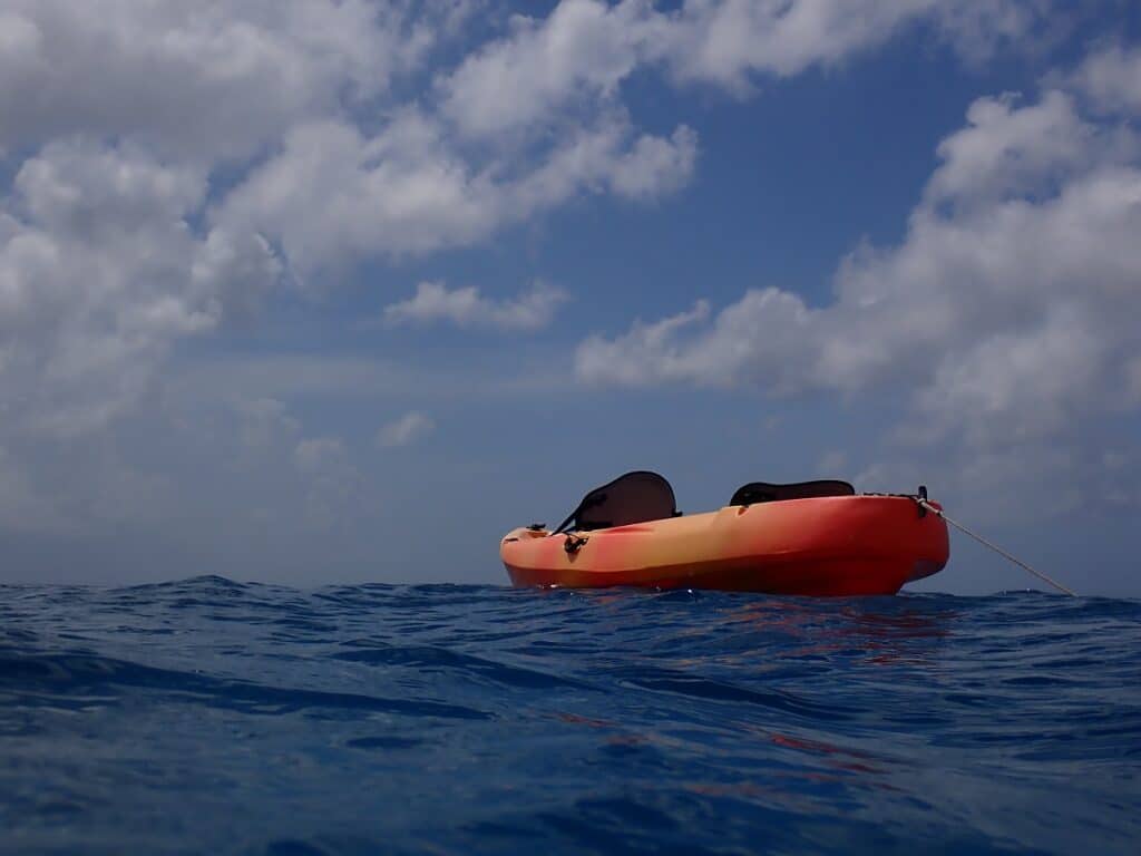 Orange kayak on the waves in the Caribbean