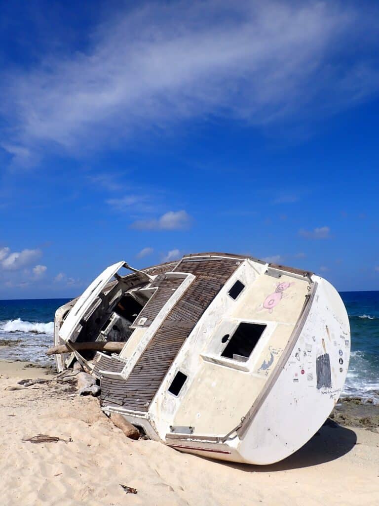 Small boat wreck stranded on the windward side of Klein Curaçao island in the Caribbean.